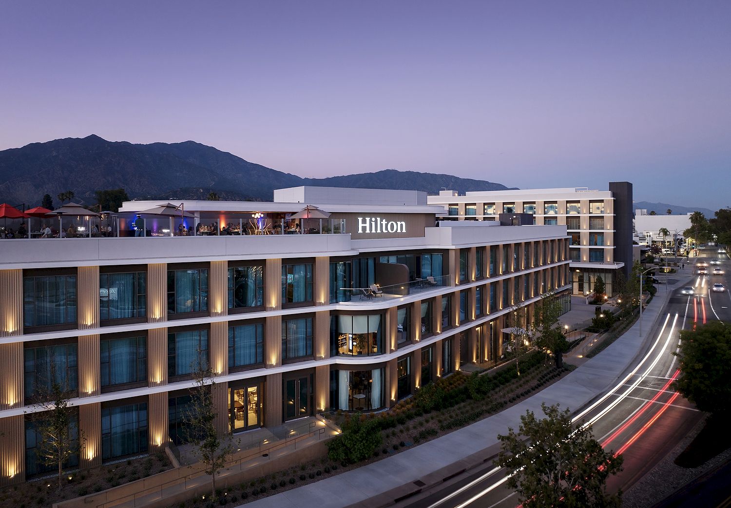 Hilton Arcadia Pasadena Area exterior at dusk on Huntington Drive with the San Gabriel Mountains
