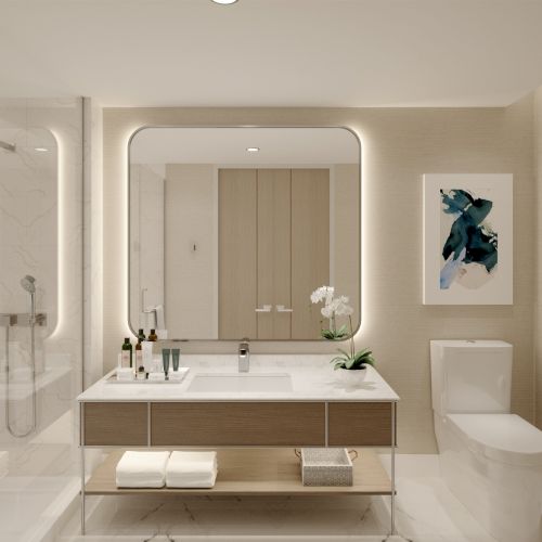 A modern bathroom with a large mirror, vanity with toiletries, toilet, shower, and abstract art on the wall.
