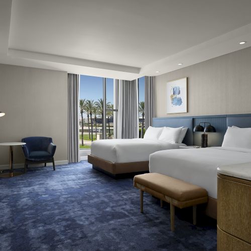Corner two queen guest room at Hilton Arcadia Pasadena Area with large windows
