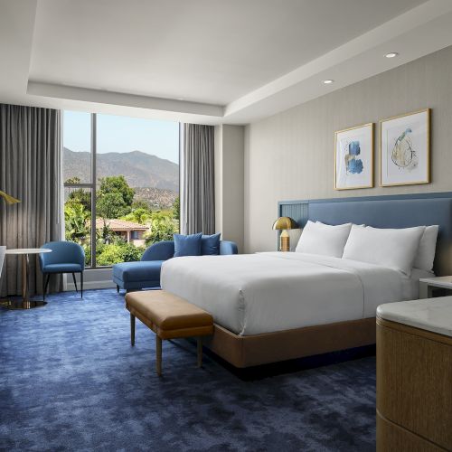 King guest room at Hilton Arcadia Pasadena Area with San Gabriel Mountain views and a seating area