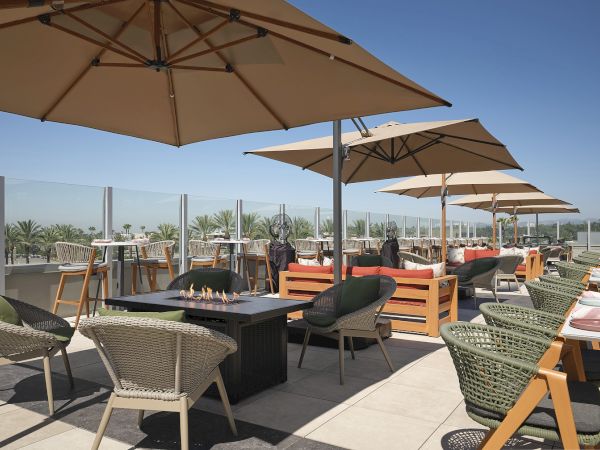 Hipico rooftop terrace at Hilton Arcadia Pasadena Area with lounge seating and fire table