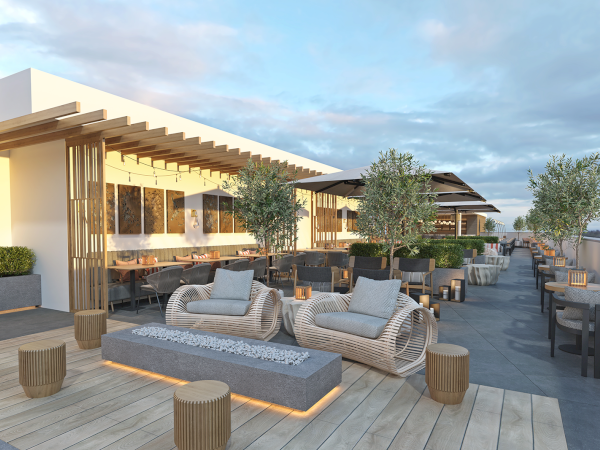 A modern rooftop terrace with seating areas, tables, and greenery under a cloudy sky, featuring cozy furniture and wooden accents.