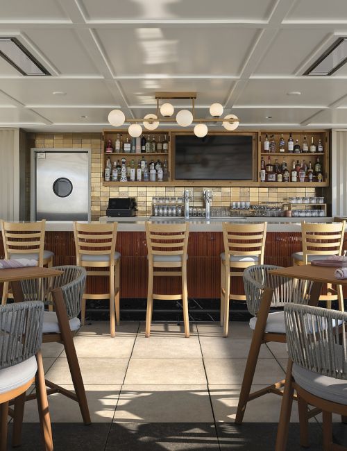 An outdoor-style restaurant bar with wooden stools, table settings, and shelves of liquor behind a built-in bar counter.